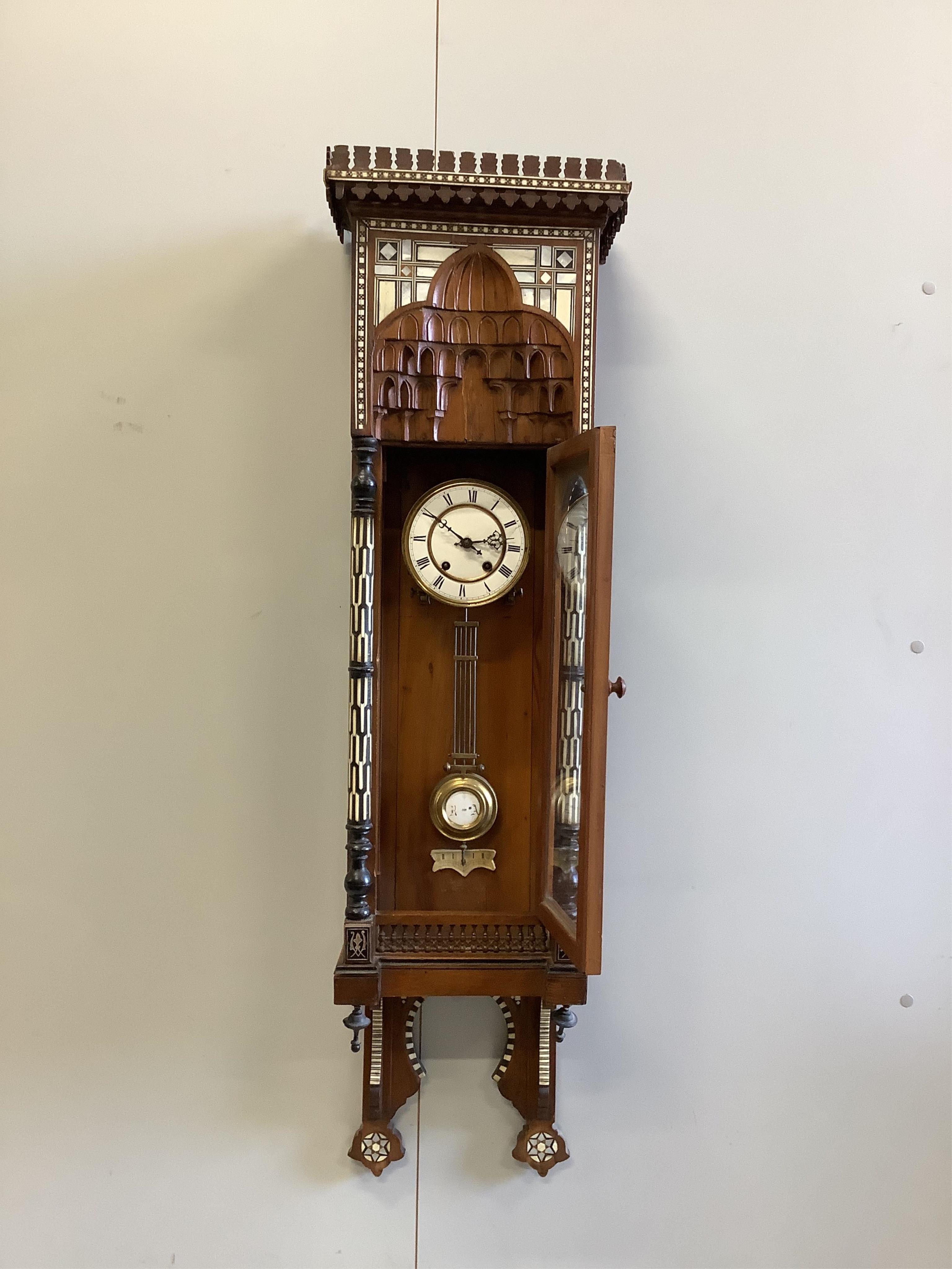 A Moorish style bone, ebony and mother of pearl inlaid wall clock, height 118cm. Condition - fair